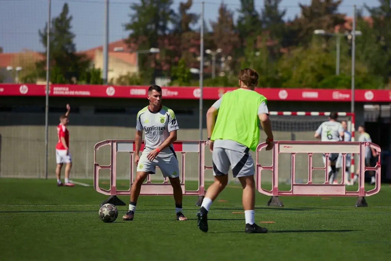 Two players closing on the ball at midfield