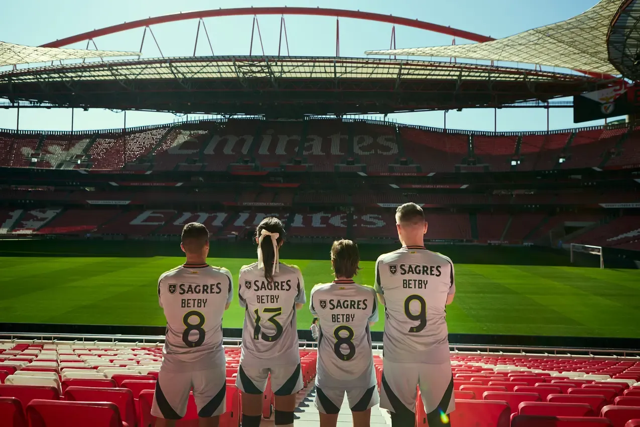 Betby shirts and squad numbers seen from behind in the stands