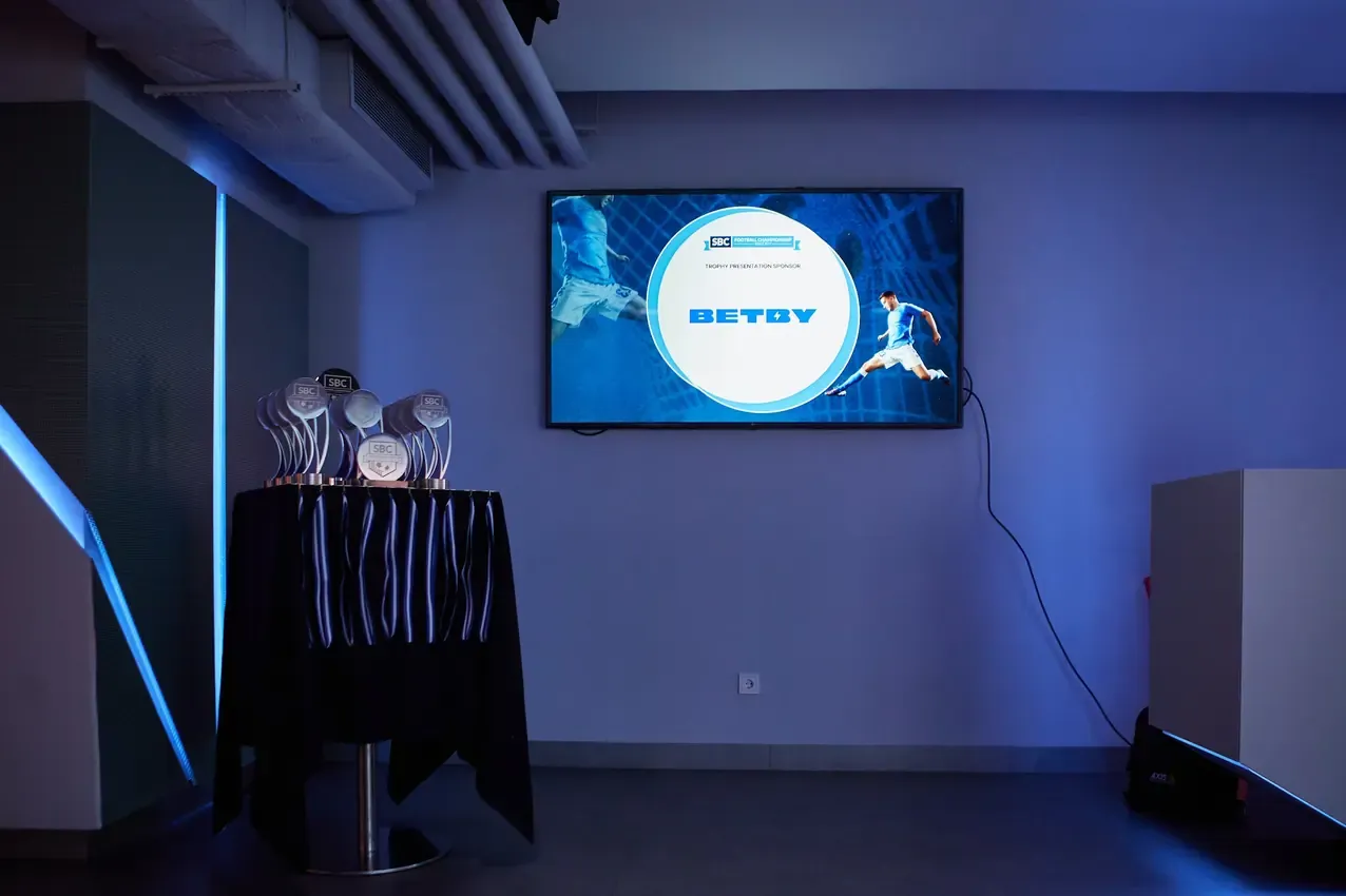 Betby screen behind the SBC Football Championship trophies