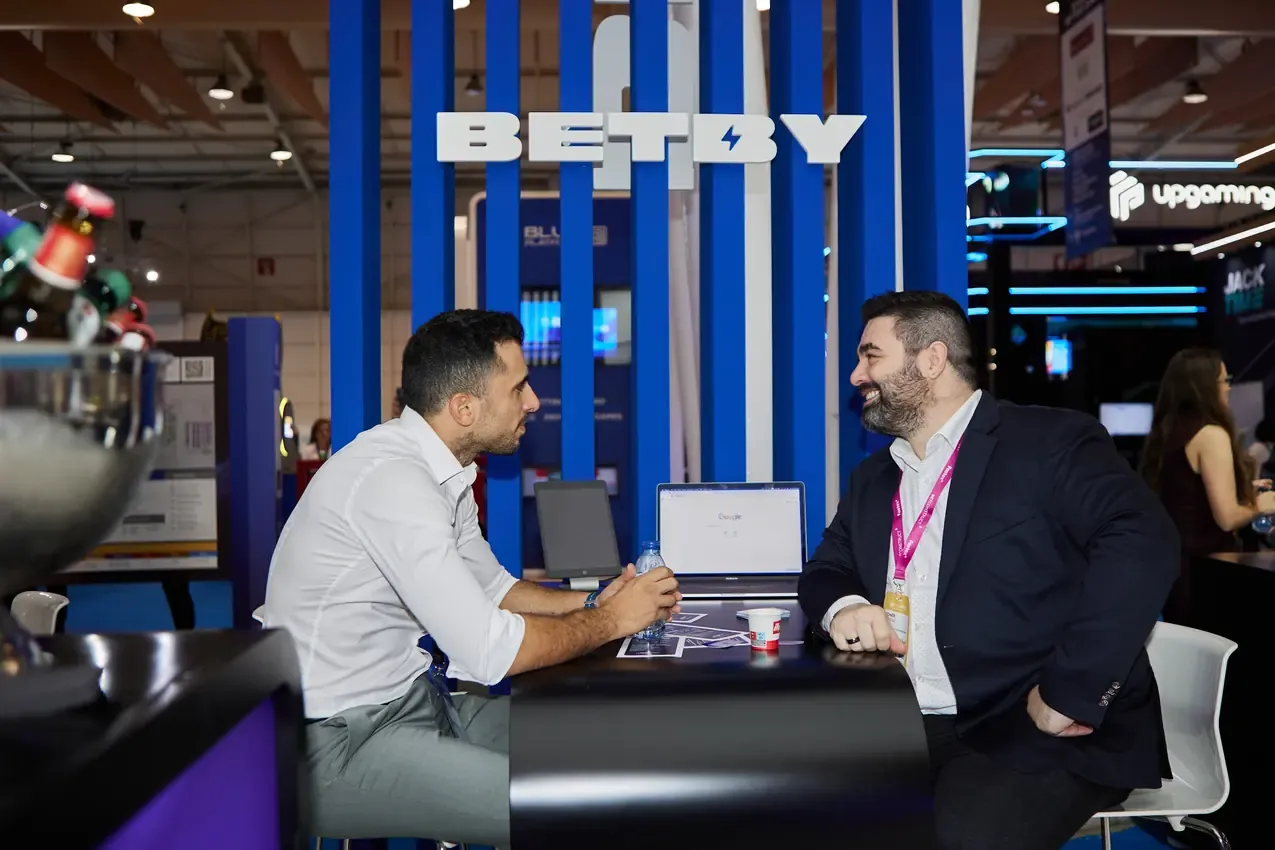 Meeting at the Betby stand table during SBC Summit 2024