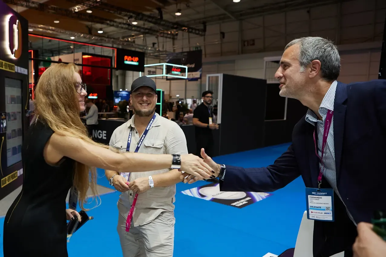 Greeting a visitor arriving at the Betby stand