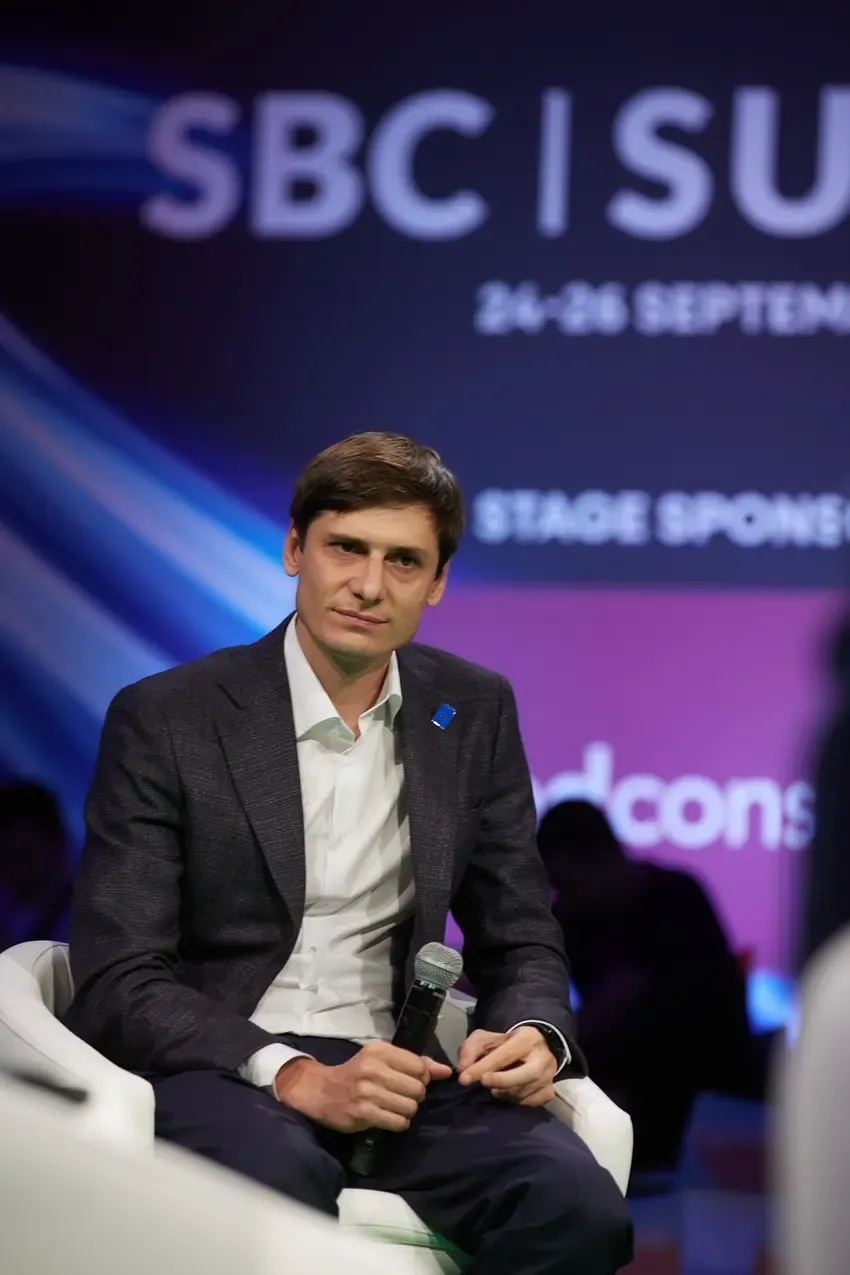 Betby speaker with a microphone on the SBC Summit stage