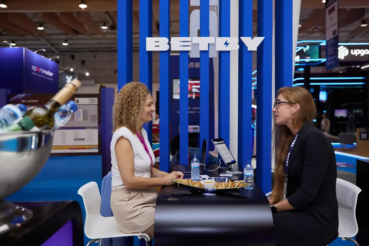 Two women in a meeting at the Betby stand