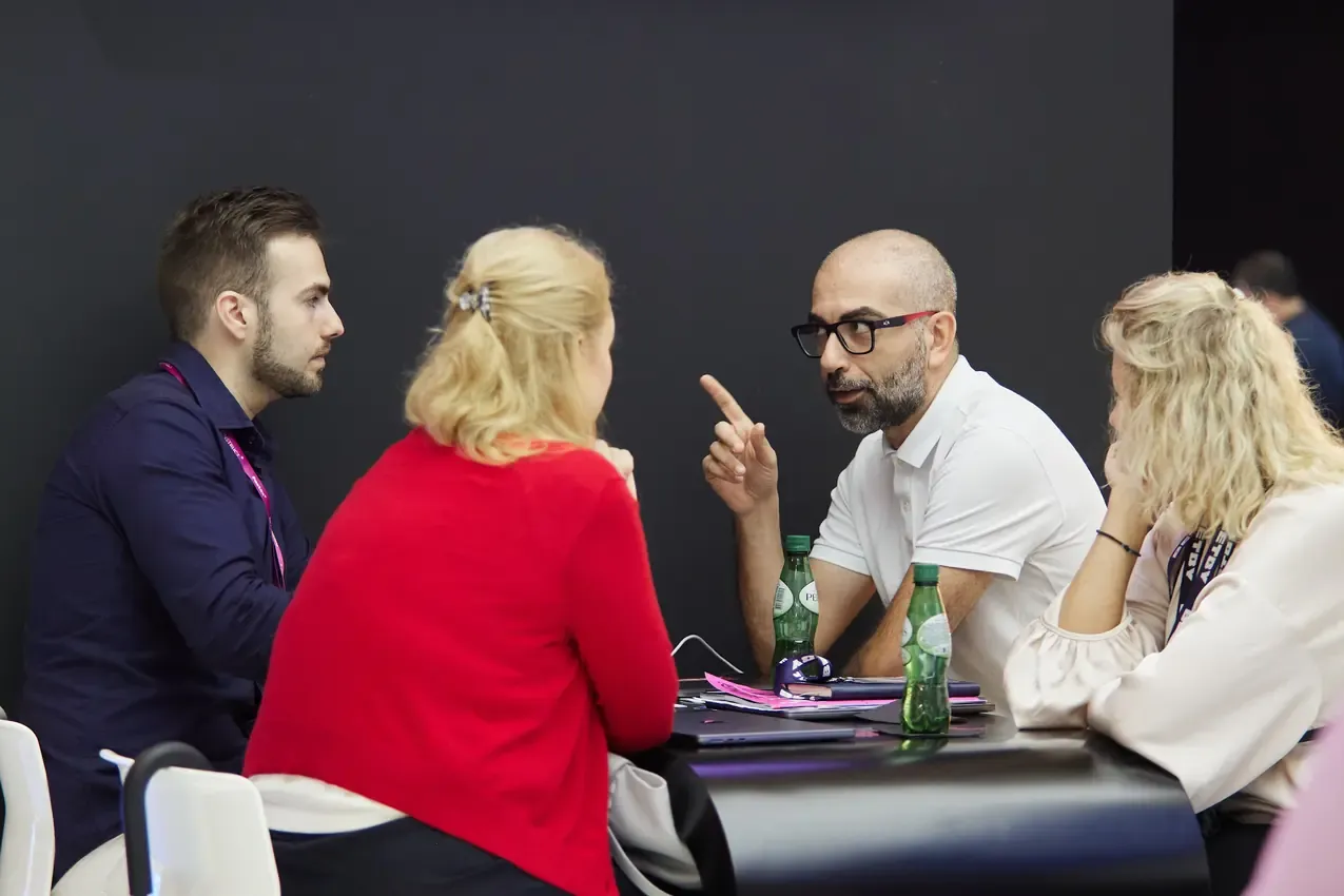 Four people in conversation at the Betby stand