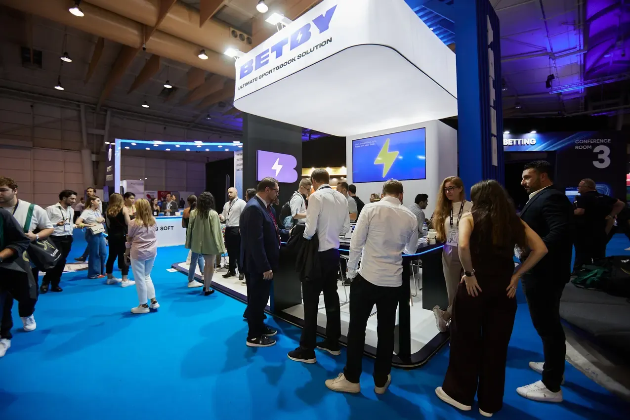 Visitors around the Betby stand on the SBC Summit 2024 floor at FIL