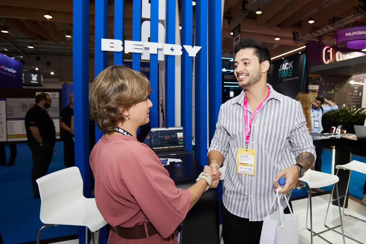 Handshake at the Betby stand on the closing day of SBC Summit 2024