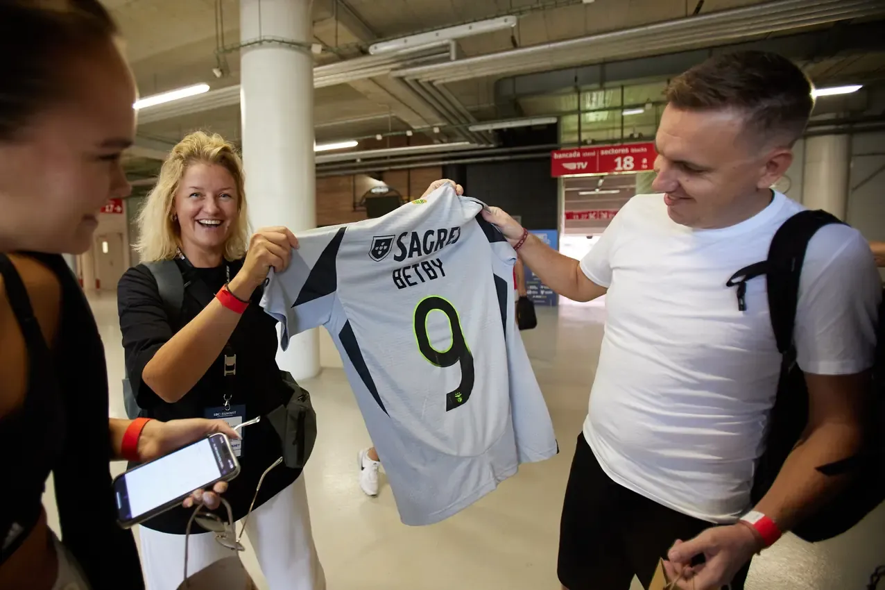 Betby number 9 shirt handed to a player before the match