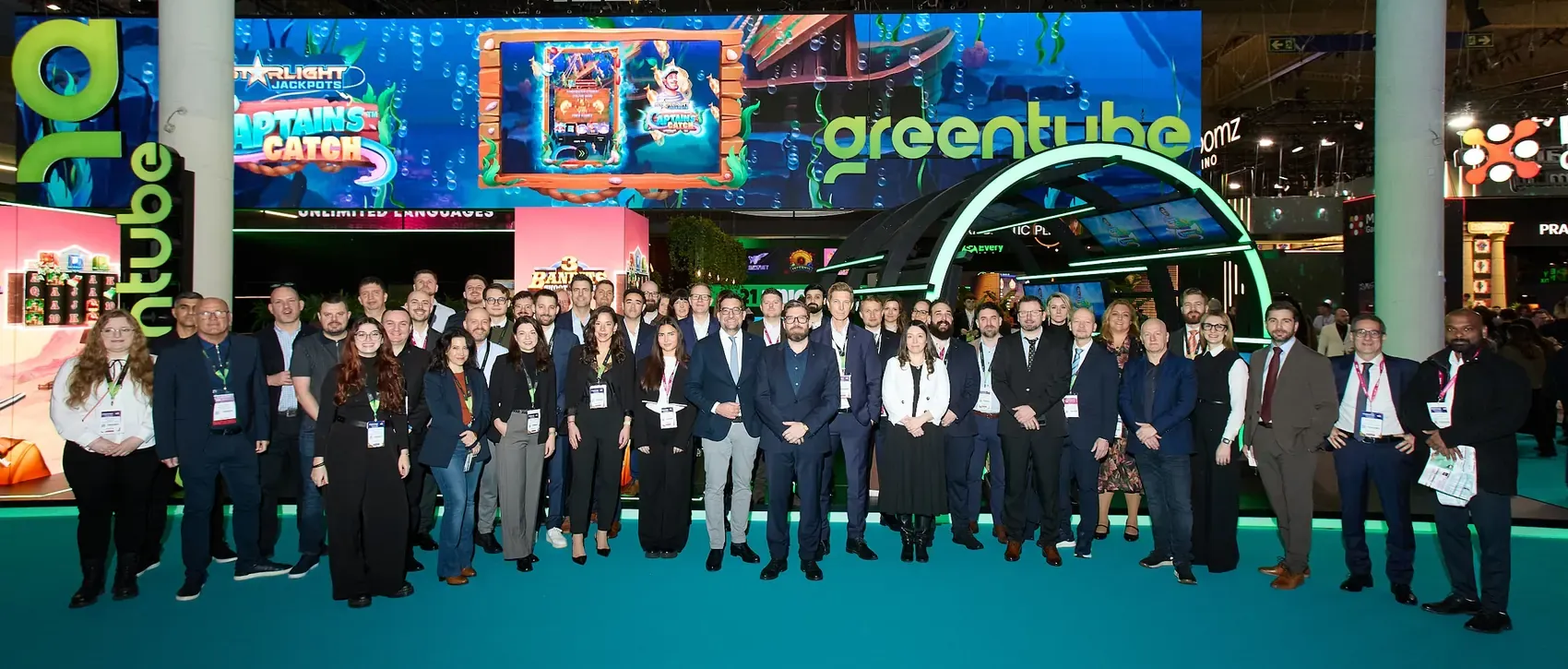 Full exhibitor team lined up at the stand before the show floor opens